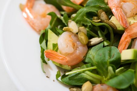 close up view of fresh green salad with shrimps and avocadoの写真素材