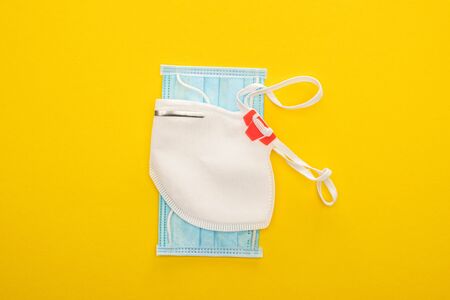 top view of medical and safety masks on yellow backgroundの写真素材