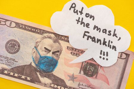 banknote with drawn medical mask and angry face expression near speech bubble on yellow background