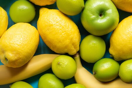 top view of yellow lemons, bananas, green apples and limes