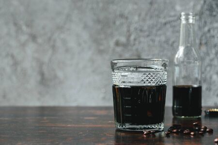 selective focus of cold brew coffee in bottle and glass near coffee beansの写真素材