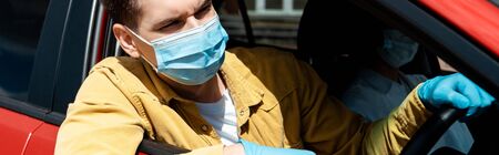 man in medical mask and protective gloves driving taxi during coronavirus pandemic, website header