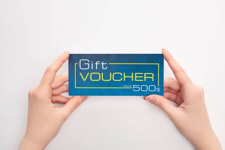 Top view of woman holding gift voucher with dollar sign on white backgroundの写真素材