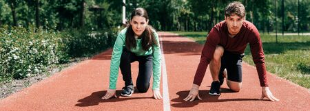 Panoramic orientation of couple standing in starting position on running path in park