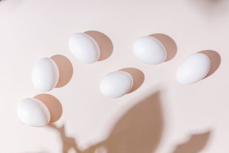 top view of white boiled chicken eggs on grey table with shadows