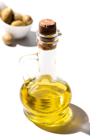 selective focus of olive oil in jar on white background