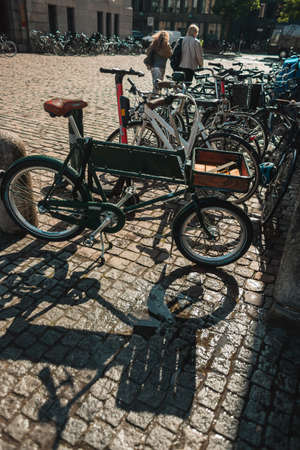 Bicycles on paving stone walkway on urban street of Copenhagen, Denmarkの写真素材