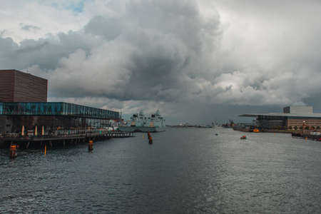 Facade of royal Danish Playhouse and river with cloudy sky at background, Copenhagen, Denmarkの写真素材