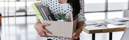panoramic crop of dismissed manager holding box with folders and documents