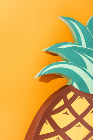 paper artwork of pineapple on orange, summer concept