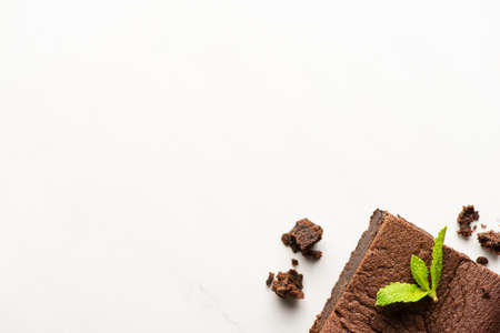 top view of delicious brownie piece with mint on white backgroundの写真素材