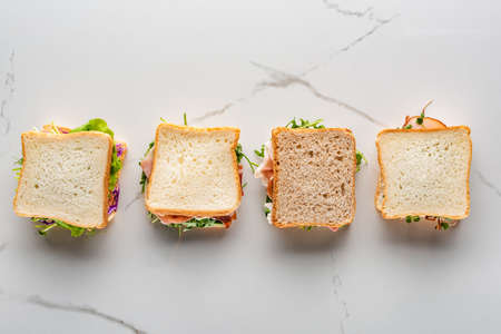 top view of fresh sandwiches on marble white surfaceの写真素材