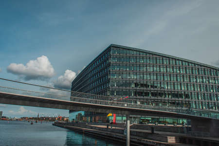 Bridge above river with building and blue sky with clouds at background in Copenhagen, Denmarkの写真素材