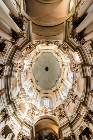 LVIV, UKRAINE - OCTOBER 23, 2019: bottom view of ceiling and columns with gilded decoration in...