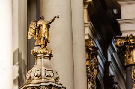 LVIV, UKRAINE - OCTOBER 23, 2019: gilded statue of archangel holding bible in outstretched hand in dominican churchのeditorial素材