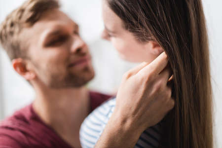 happy beautiful young couple hugging at home, selective focusの写真素材
