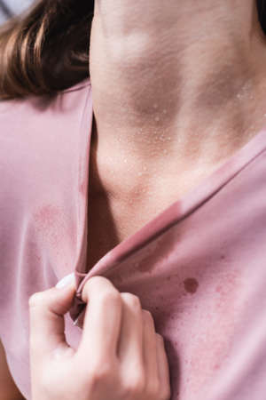 cropped view of sweaty girl suffering from heat at homeの写真素材