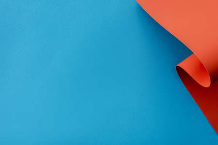 orange colorful paper swirl on blue backgroundの写真素材