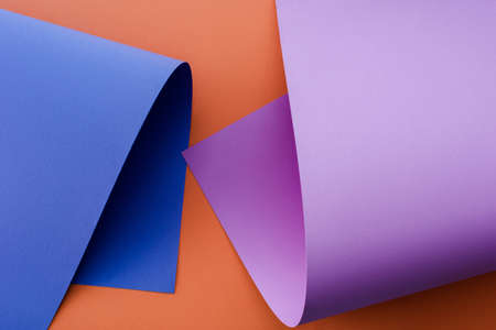 blue and violet colorful paper on orange background