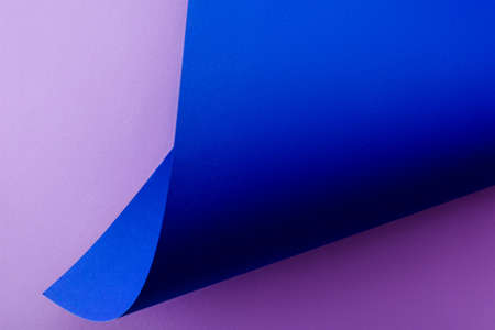 curved blue paper on violet backgroundの写真素材