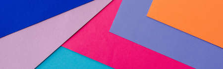 abstract geometric background with orange, pink, blue and violet paper, panoramic shotの写真素材