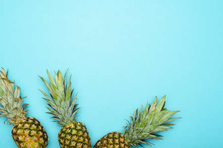 top view of ripe pineapples on blue backgroundの写真素材