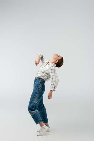 attractive girl posing like puppet isolated on gray