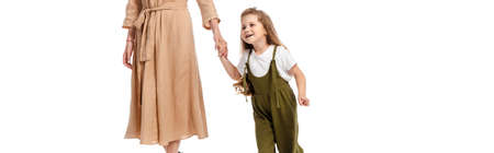 panoramic crop of mother and cute daughter holding hands isolated on white