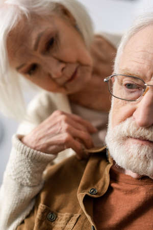 selective focus of senior woman looking at husband with dementia diseaseの写真素材