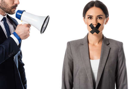 bearded businessman holding megaphone near businesswoman with duct tape on mouth isolated on white,...