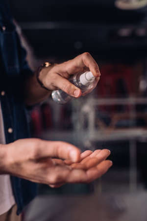 selective focus of businessman spraying sanitizer on handの写真素材