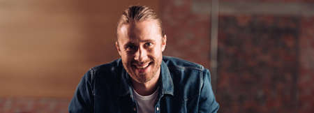 website header of cheerful bearded businessman looking at camera