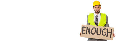 Panoramic shot of engineer holding signboard with enough lettering isolated on whiteの写真素材