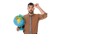 Panoramic shot of shocked teacher holding eyeglasses and globe isolated on white