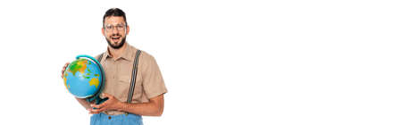 Horizontal image of positive nerd in suspenders holding globe isolated on whiteの写真素材
