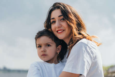 cheerful woman looking at camera and smiling near sonの写真素材