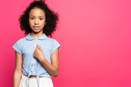 cute curly african american kid pointing with finger at herself isolated on pink