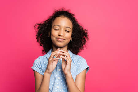 cunning cute curly african american kid isolated on pinkの写真素材