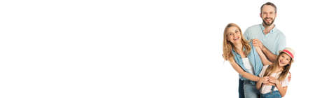 happy family smiling at camera isolated on white, panoramic shotの写真素材