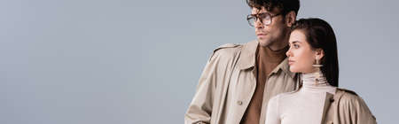website header of fashionable couple looking away isolated on grayの写真素材