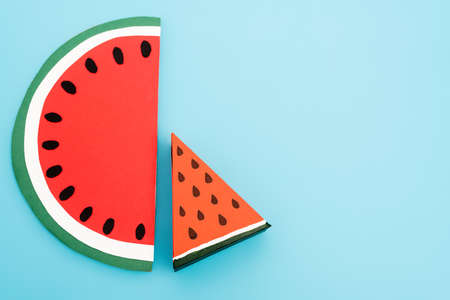 top view of paper watermelon slices on blue backgroundの写真素材