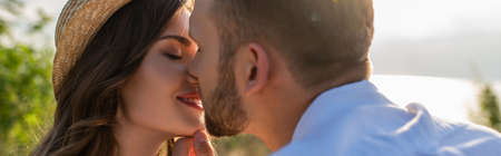 panoramic concept of bearded man kissing happy young womanの写真素材