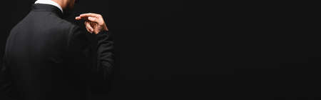 panoramic concept of priest gesturing isolated on black