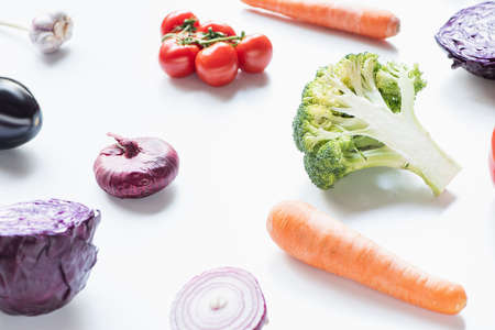 fresh ripe colorful vegetables scattered on white backgroundの写真素材