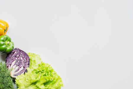 top view of bell peppers, red cabbage, greens on white backgroundの写真素材