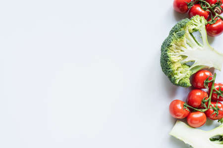 top view of colorful broccoli and tomatoes on white backgroundの写真素材