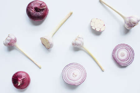 top view of scattered red onion and garlic on white backgroundの写真素材