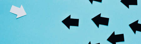 panoramic shot of black and white arrows on blue background, leadership conceptの写真素材