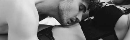 panoramic crop of shirtless man kissing seductive woman in underwear relaxing on bed at home