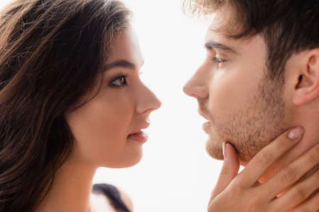 side view of woman and man looking at each other isolated on white
